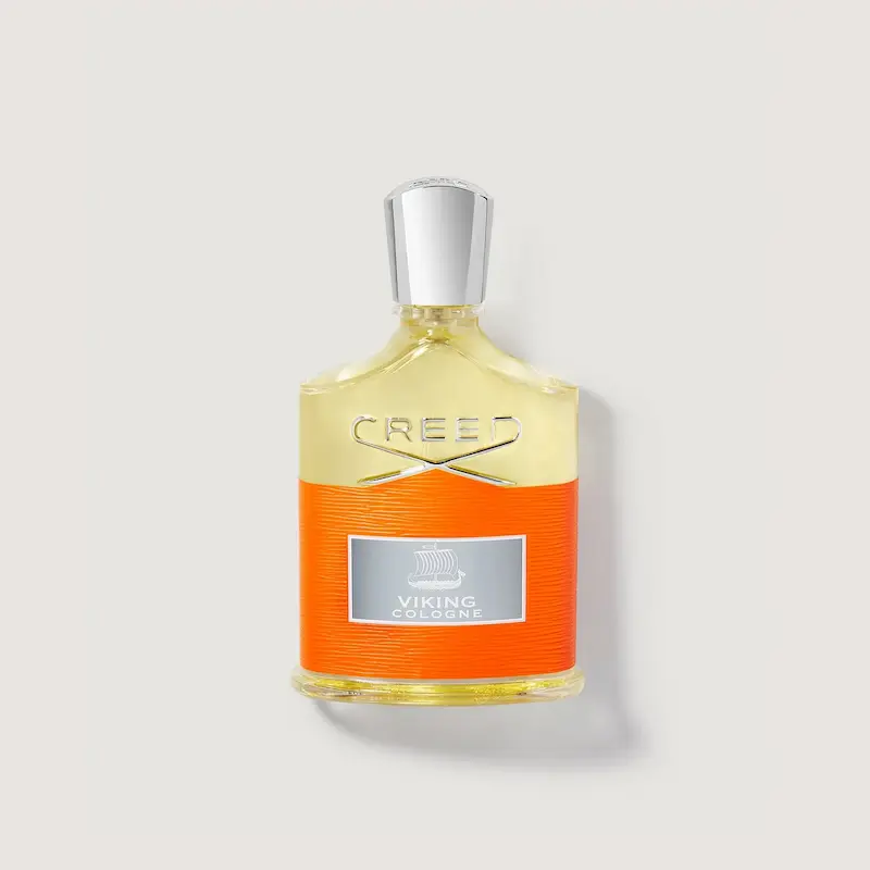 Creed Viking Cologne 2021 bottle with citrus and herbal notes, displayed against a Nordic spring-inspired background